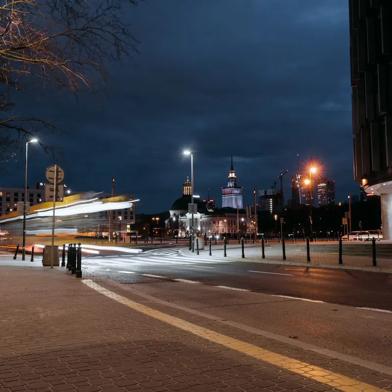 Dynamic night scene of urban city with moving lights and modern buildings.