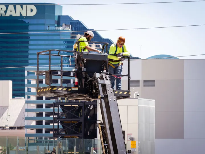 Construction workers perform exterior maintenance on a high-rise in Las Vegas.