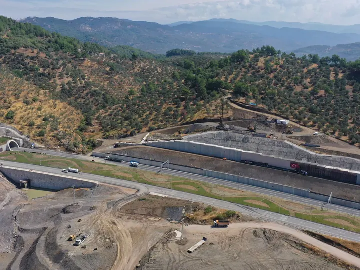 Aerial view of road construction in Küçükçetmi, Çanakkale, Turkey amidst the scenic hills.